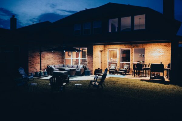 brown wooden table and chairs Brick building during night time